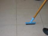 A cleaner applying agitation to tile.